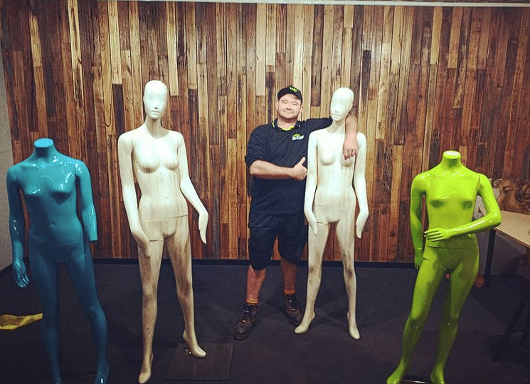 Junk dude standing with mannequins