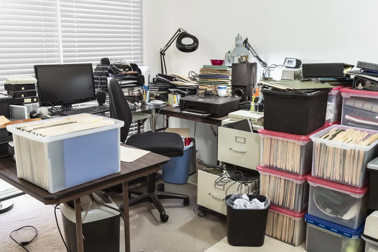 Business Office With Cluttered Desk and Boxes Full of Files